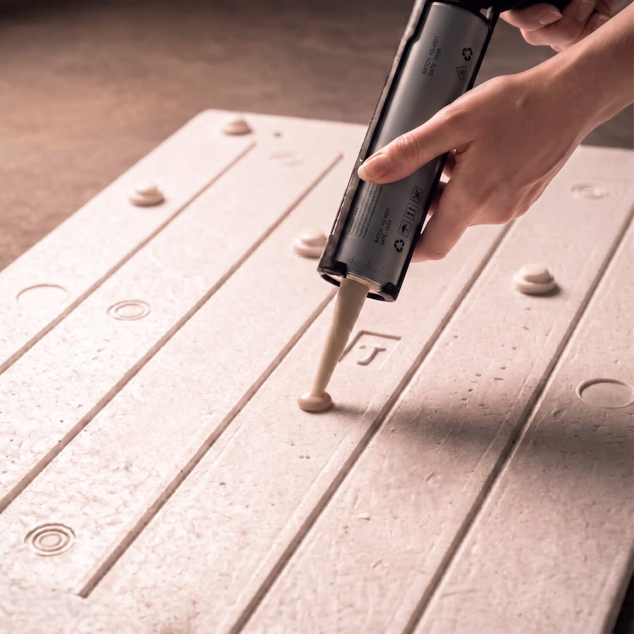 Dots of adhesive on the back of a panel