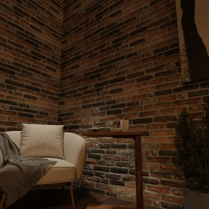 Earthcore 3D faux brick wall panel used in a cozy living room corner with a white armchair and wooden side table.