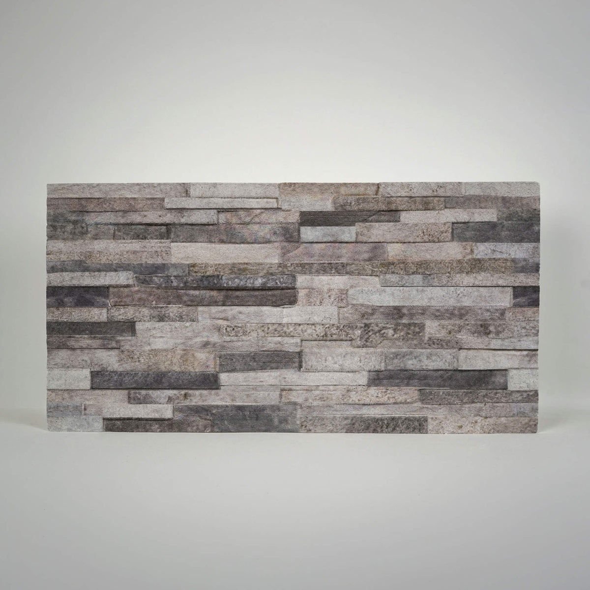 Onyx 3D faux stacked stone styrofoam wall panel with cool grey tones